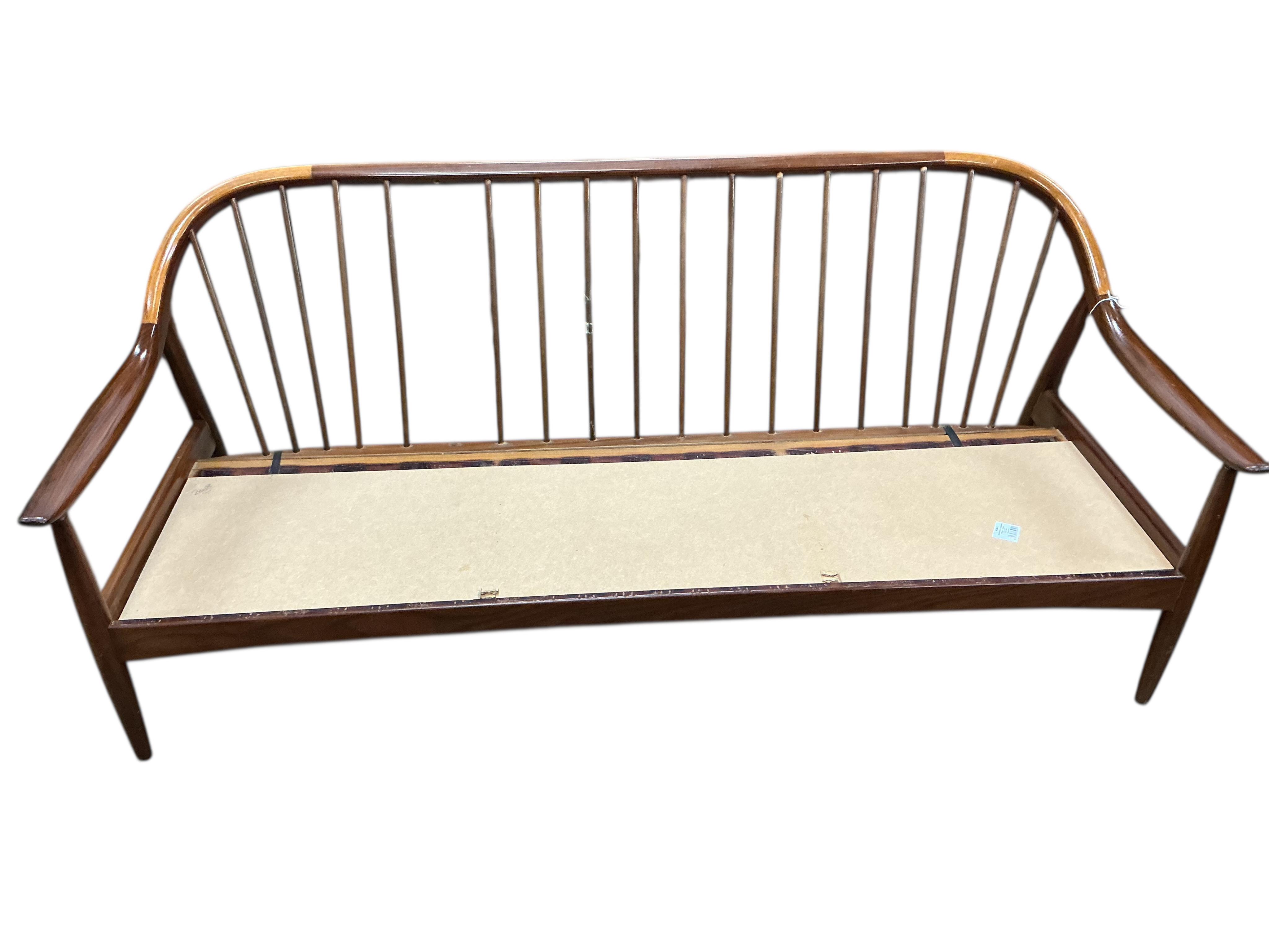 Greaves and Thomas: A mid century teak stick back sofa, width 168cm, depth 70cm, height 70cm